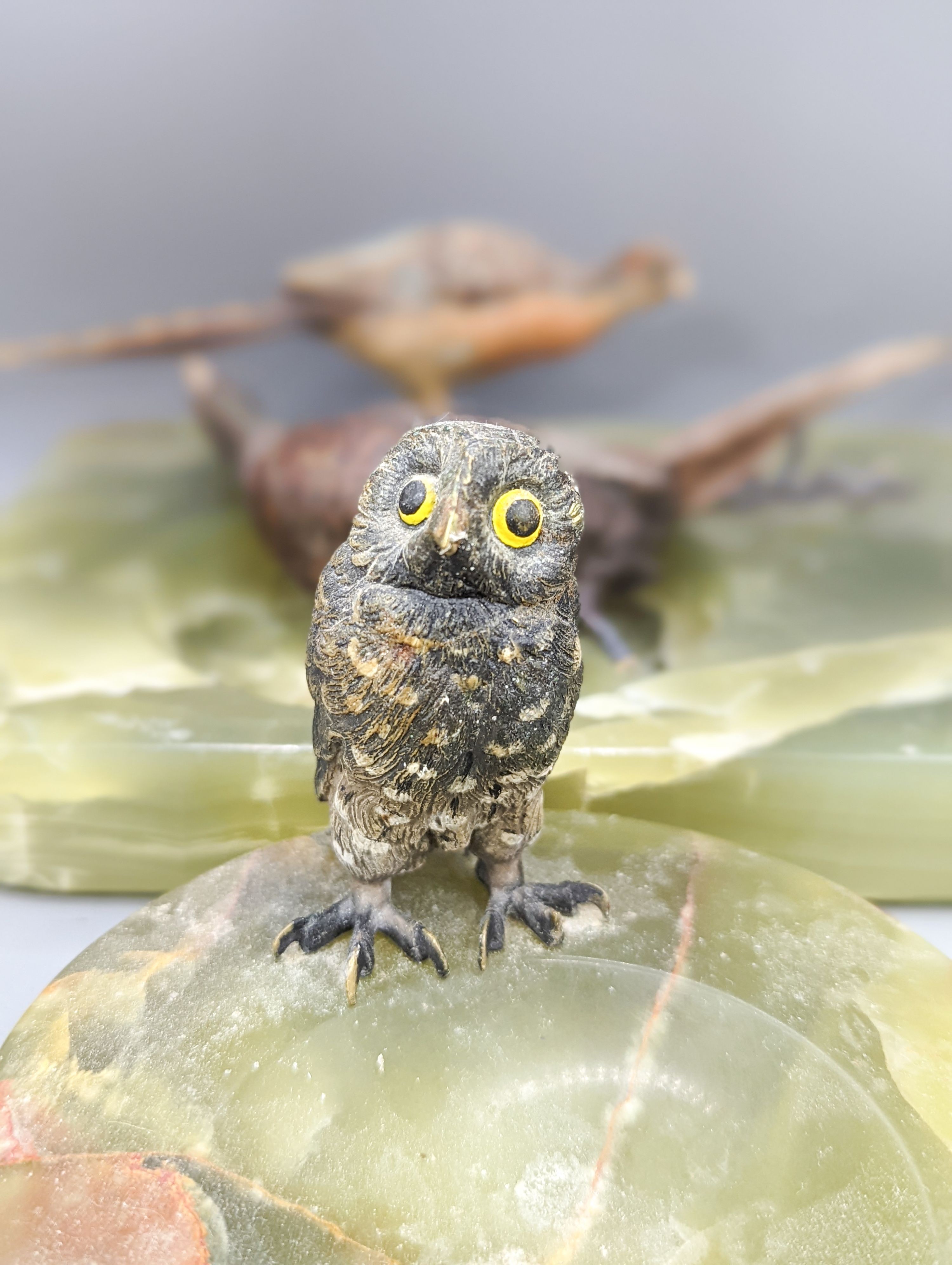 A green onyx ash stand, mounted with cold painted bronze pheasants and another, mounted with a model of an owl (2)